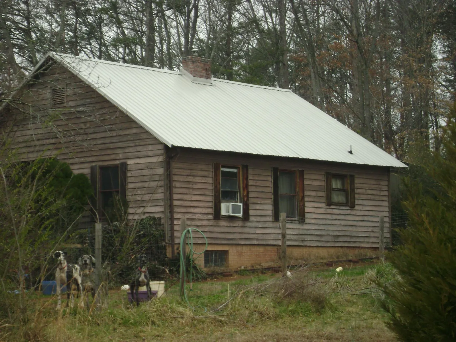 White metal roof on an old wood sided farmhouse, from a Metal Roof Installation job in Amityville